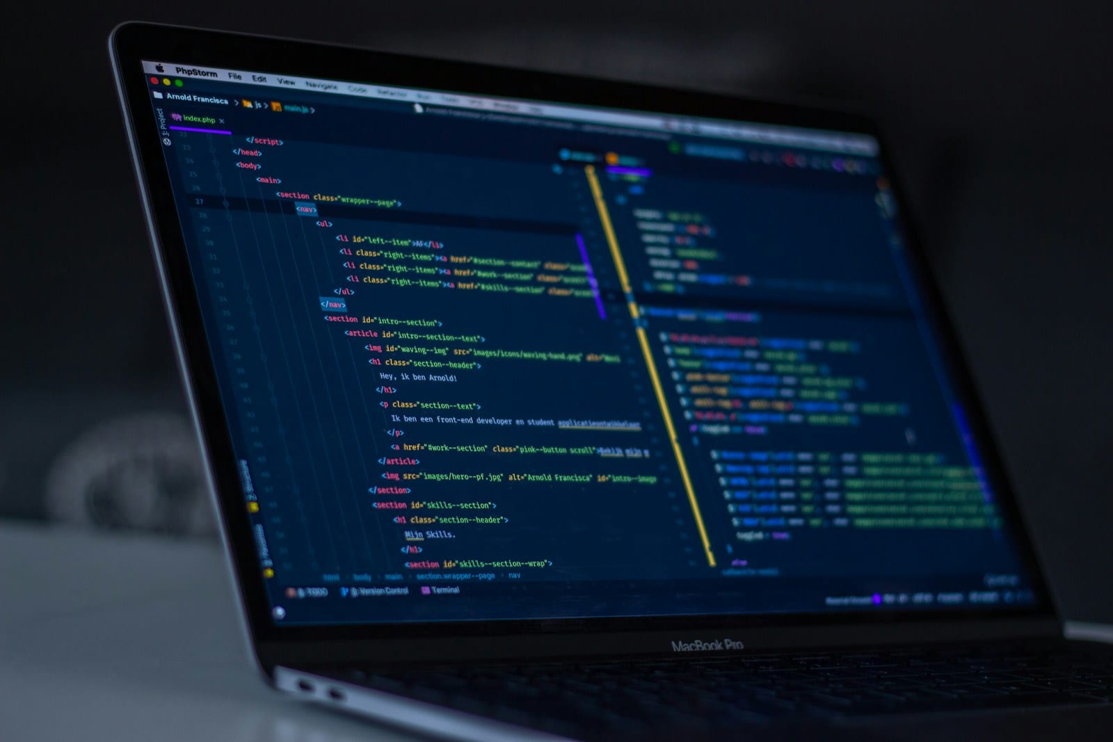 A MacBook Pro displaying lines of code, representing editing a website configuration file